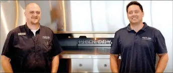  ?? Michael Burchfiel/Herald-Leader ?? Matt Bookout and Kyle Cook, both members of Pieology’s management in Siloam Springs, stand in front of their new pizza oven. Pieology’s soft opening on Saturday will benefit local charity Dustin’s Dream.