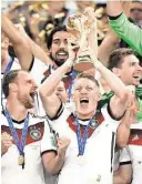  ??  ?? Germany’s Bastian Schweinste­iger raises the trophy after the World Cup final in Rio de Janeiro.