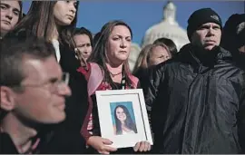  ?? Alex Wong Getty Images ?? LORI AND ILAN Alhadeff, with a portrait of daughter Alyssa, who was among 17 killed in Parkland, Fla., attend a gun-control event in Washington in March.