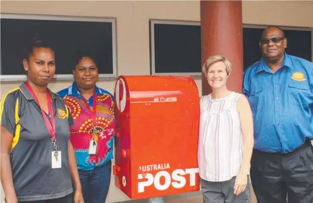  ??  ?? TEAM EFFORT: Yarrabah Post Office employees Tammie Singleton and Nulyssah Bulmer with Yarrabah Aboriginal Shire Council corporate services manager Jemma Lichtenfel­d and Mayor Ross Andrews.