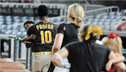  ?? MITCHELL LAYTON GETTY IMAGES ?? Jurickson Profar of the San Diego Padres runs off the field with family after shots were heard outside Nationals Park on Saturday.