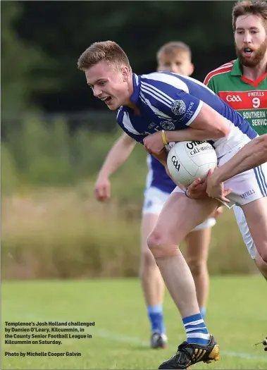  ?? Photo by Michelle Cooper Galvin ?? Templenoe’s Josh Holland challenged by Damien O’Leary, Kilcummin, in the County Senior Football League in Kilcummin on Saturday.