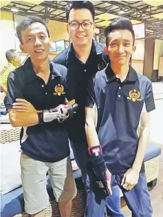  ??  ?? Elite’s bowlers (from left) Lim Cho Kwang,Willie Chung and Adrian Koh clinched the MAW 199 & Below Trios League crown.