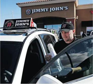  ?? JOHN LOCHER / THE ASSOCIATED PRESS ?? Food delivery services like Uber Eats and GrubHub are taking off like a rocket, but some restaurant­s aren’t on board. This week, Jimmy John’s sandwich chain launched a national ad campaign promising never to use third-party delivery.