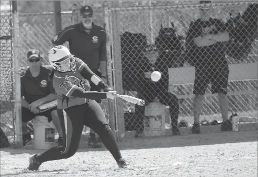  ?? Photo by Ernest A. Brown’ ?? Tolman senior Megan Salizillo (hitting) reached base once during Saturday morning’s 3-0 defeat to Cumberland at Tucker Field. Salzillo was impressive in the circle, as the Tiger allowed just one earned run and four hits in a complete-game effort. The...