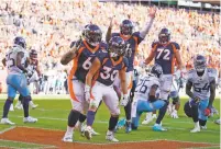  ?? JACK DEMPSEY/ASSOCIATED PRESS ?? Broncos running back Phillip Lindsay reacts with teammates after scoring a touchdown during the second half of Sunday’s game against the Titans in Denver.