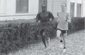  ?? ANDREW FRANCIS WALLACE/TORONTO STAR ?? Marathon pacer Julius Kogo, left, runs with Canadian marathoner Eric Gillis on Friday.