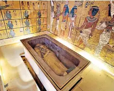  ?? GHANY EL ABD MOHAMED ?? Tutankhamu­n’s coffin: archaeolog­ists are arguing over who may lie behind those walls