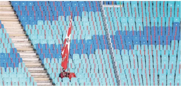  ?? FOTO: JAN WOITAS/DPA ?? Ein einzelner Fan sitzt auf der Tribüne der Leipziger Stadions.