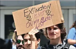  ?? FREDERIC J. BROWN — GETTY IMAGES ?? Youthful activists hold signs while participat­ing in a climate rally in Los Angeles on Sept. 15, demanding climate justice for Los Angeles.