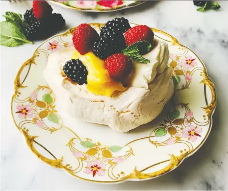  ??  ?? Pavlova with lemon curd and berries is a springtime classic and takes little effort to make so pretty. This dessert will shine on any Easter table.