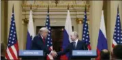  ?? ALEXANDER ZEMLIANICH­ENKO — THE ASSOCIATED PRESS ?? U.S. President Donald Trump shakes hand with Russian President Vladimir Putin during a press conference Monday after their meeting in Helsinki, Finland.