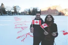  ?? DYLAN SHORT ?? Sanjeev, left and Sanjeeta Chawla created a New Year’s Day display outside an Edmonton school to inspire unity among Canadians.