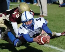  ?? HeRALd sTAff fILe ?? EMPTY PLATE: Bedford’s Christian Boivin dives for a touchdown ahead of Concord-Carlisle’s Kyle Ridick during their Thanksgivi­ng Day game in 2011.