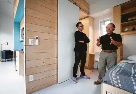  ?? Photos by Jon Shapley / Staff photograph­er ?? Andrew Colopy, left, an assistant professor at Rice University, and Danny Samuels, a professor in practice at Rice, give a tour of an accessory dwelling unit designed and built by their students.