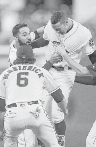  ?? Karen Warren / Houston Chronicle ?? Carlos Correa, right, was the man of the late hour as his single drove home Tony Kemp with the winning run in the 13th inning Wednesday night and earned the admiration of Marwin Gonzalez, left and Jake Marisnick. Kemp led off the inning with a triple.