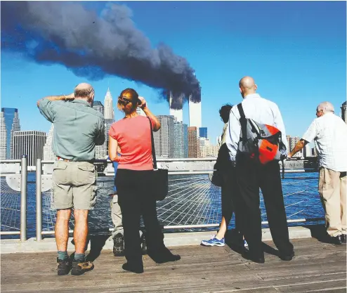  ?? HENNY RAY ABRAMS / AFP VIA GETTY IMAGES FILES ?? On the morning of Sept. 11, 2001, New Yorkers woke to crisp, cloudless blue skies — little portent of the dark,
history-changing day that was to come and that would remain etched on the memories of those affected.