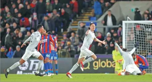  ?? MATTHEW CHILDS / ACTION IMAGES VIA REUTERS ?? Nemanja Matic wheels away, followed by teammate Chris Smalling, after scoring Manchester United's injury-time winner at Selhurst Park, London, on Monday night. The come-from-behind triumph lifted United back into second place above Liverpool, which...