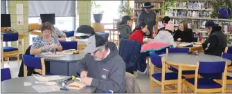  ?? ?? Red River cart building workshop participan­ts build their own miniature carts, March 5.