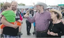  ?? LARRY MACDOUGAL/ THE CANADIAN PRESS ?? Elijah Day, 3, being held by father Rod Day, meets NDP Leader Thomas Mulcair and wife, Catherine, July 4.