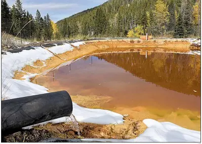  ?? AP ?? Water contaminat­ed with arsenic, lead and zinc flows out of a mine last fall near Rimini, Mont. Environmen­talists arguing for the mining-pollution rule had claimed that the proposal would help ensure mining companies would pay to clean up water-fouling spills.