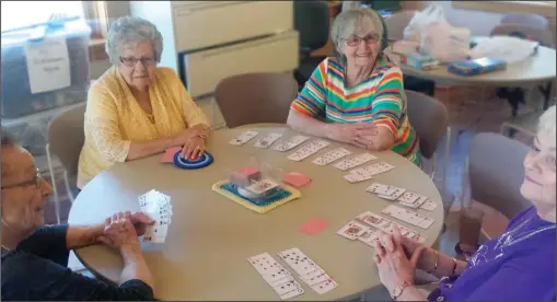  ??  ?? Linda Miller, Joan Mitchell, Dolly Gray, and Barbara McClelland play a game of canasta.