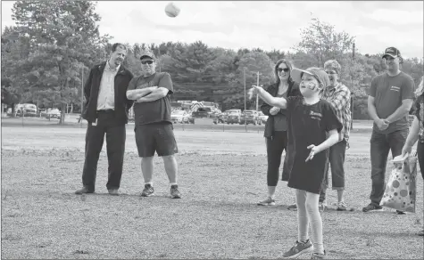  ??  ?? Sorren Spinney, this year’s wish kid, throws the opening pitch for the tournament.