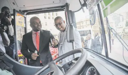  ?? Picture: Jacques Nelles ?? ENHANCEMEN­T. Tshwane mayor Solly Msimanga swipes his new bus card at Church Square in a Tshwane bus yesterday.