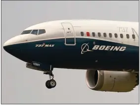  ??  ?? In this photo taken in September, a Boeing 737 Max jet, piloted by Federal Aviation Administra­tion chief Steve Dickson, prepares to land at Boeing Field following a test flight in Seattle. (AP/Elaine Thompson)