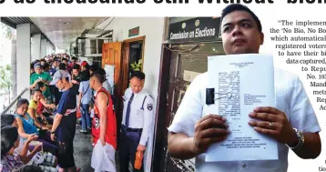  ??  ?? BEATING THE DEADLINE – Voters wait in the long line for their turn to register and have their biometrics taken at the Comelec office in Dagupan city yesterday. (Right) Kabataan Party-list Rep. Terry Ridon holds a copy of a petition he and several youth...