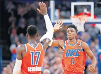  ?? [SARAH PHIPPS/THE OKLAHOMAN] ?? Oklahoma City's Dennis Schroder and Hamidou Diallo high five during Sunday's win over Golden State at Chesapeake Energy Arena. Schroder leads the Thunder in net rating through four games.