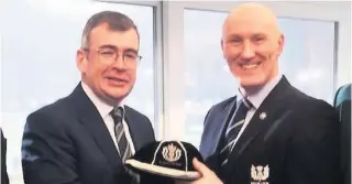  ??  ?? Handshake Chief Superinten­dent Gordon Crossan, second from right, is presented with a Police Scotland Cap by Irish Rugby president Ian McIlraith, An Gard Siochana Commission­er, for his services to Scottish Police Rugby