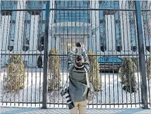  ?? JUSTIN TANG THE CANADIAN PRESS ?? A news photograph­er takes pictures outside the Embassy of the Russian Federation to Canada in Ottawa on Monday. Foreign Affairs Minister Chrystia Freeland says Canada is expelling four Russian diplomats.