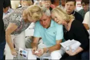  ?? PATRICK SEMANSKY - THE ASSOCIATED PRESS ?? Carl Hiaasen, center, brother of Rob Hiaasen, one of the journalist­s killed in the shooting at The Capital Gazette newspaper offices, is consoled by his sisters Barb, left, and Judy during a memorial service, Monday, in Owings Mills, Md.