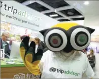  ?? REUTERS ?? A TripAdviso­r mascot welcomes guests to its stand at a tourism trade fair in Berlin, Germany.