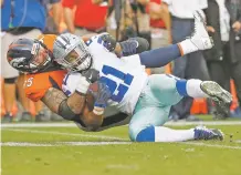  ?? JACK DEMPSEY/AP FILE PHOTO ?? Cowboys running back Ezekiel Elliott is stuffed by Broncos defensive end Derek Wolfe on Sept. 17 in Denver. The Raiders’ Marshawn Lynch will be the latest test for the Broncos defense on Sunday at Sports Authority Field at Mile High.