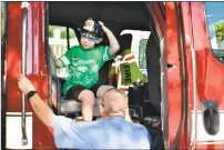  ??  ?? Kindergart­ner Carter Flinn arrives for the first day of school in a Torrington Fire Department truck on Wednesday at Vogel-Wetmore School.