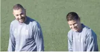  ?? — AFP ?? Real Madrid forward Karim Benzema (left) and James Rodriguez smile as they attend a training session.