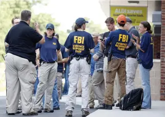  ??  ?? Law enforcemen­t officers gather near a shooting scene at baseball field in Alexandria where House Majority Whip Steve Scalise was shot during a Congressio­nal baseball practice. (AP)