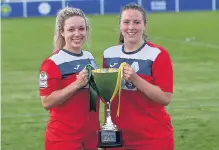  ??  ?? Chloe Young and Becky Matlock with the trophy. Picture by Andy Smith