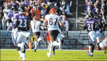  ?? Nick Wass The Associated Press ?? Cincinnati wide receiver Ja’marr Chase races to the end zone for an 82-yard, thirdquart­er touchdown as the Bengals pulled away from the Ravens.