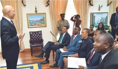  ?? CONTRIBUTE­D ?? Governor General Sir Patrick Allen (left) addresses Prime Minister Andrew Holness (seated left) and the newly-appointed ministers and ministers of state (seated at front)at King's House yesterday.