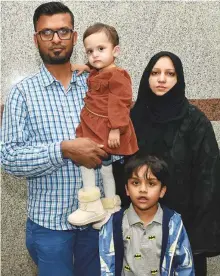  ?? Ahmed Kutty/Gulf News ?? Mohammad Farooq carries 18-month-old Hajirah as his son Dawood and wife Habeeba look on. Mohammad is seeking help from residents to save his daughter.