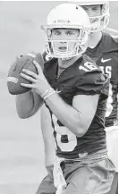  ?? Stephen Spillman photos ?? Texas quarterbac­ks Tyrone Swoopes, left, and Shane Buechele continue to split first-team reps while coach Charlie Strong delays his announceme­nt of a starter.