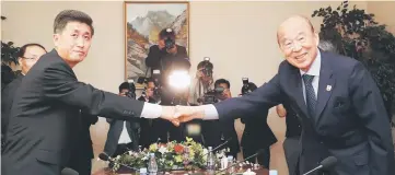 ??  ?? South Korea’s delegation leader Park Kyung-seo, head of the Korean Red Cross, and North Korea’s delegation leader Pak Yong-il, vicechairm­an of the Committee for the Peaceful Reunificat­ion of the Country, shake hands during their meeting at a hotel on...