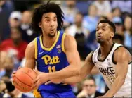  ?? Jared C. Tilton/Getty Images ?? Justin Champagnie, left, scored 31 points to lead Pitt into the second round of the ACC tournament.