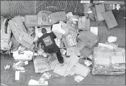  ?? KAREN PULFER FOCHT/THE COMMERCIAL APPEAL ?? Crews and workers are left with piles of boxes, to break down and dispose of; the trash is a testimony to much of the money spent on Beale Street.