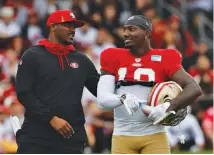  ?? AP FILE PHOTO/JOSIE LEPE ?? San Francisco 49ers receiver Deebo Samuel, right, chats with defensive backs coach Daniel Bullocks during practice in Santa Clara, Calif. Bullocks was a star on the Chattanoog­a prep scene at Hixson.