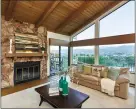  ??  ?? The family room features a massive stone fireplace and views.