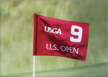  ?? AP PHOTO ?? The flag on the ninth hole blows in the wind during a practice round for the U.S. Open golf tournament Wednesday at Erin Hills in Erin, Wis.